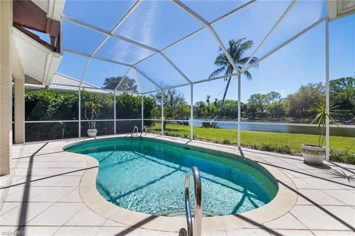 Pool featuring a yard, a water view, a lanai, and a patio area