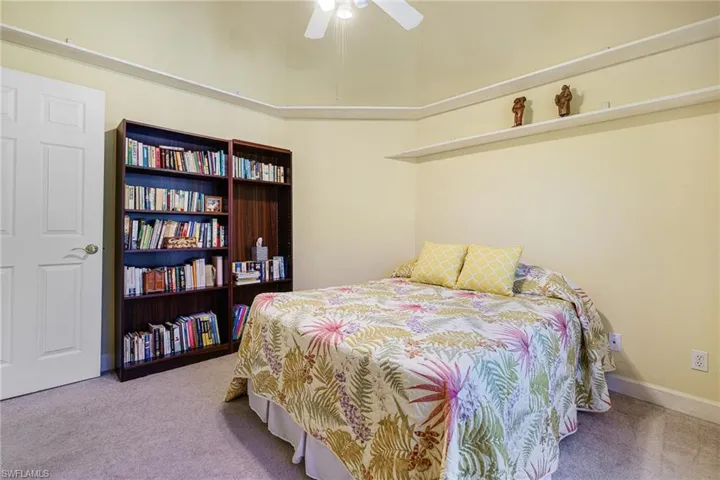 Bedroom with baseboards, a ceiling fan, and carpet flooring