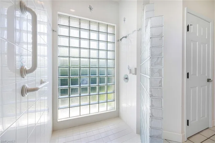 Full bathroom featuring a tile shower and tile patterned floors