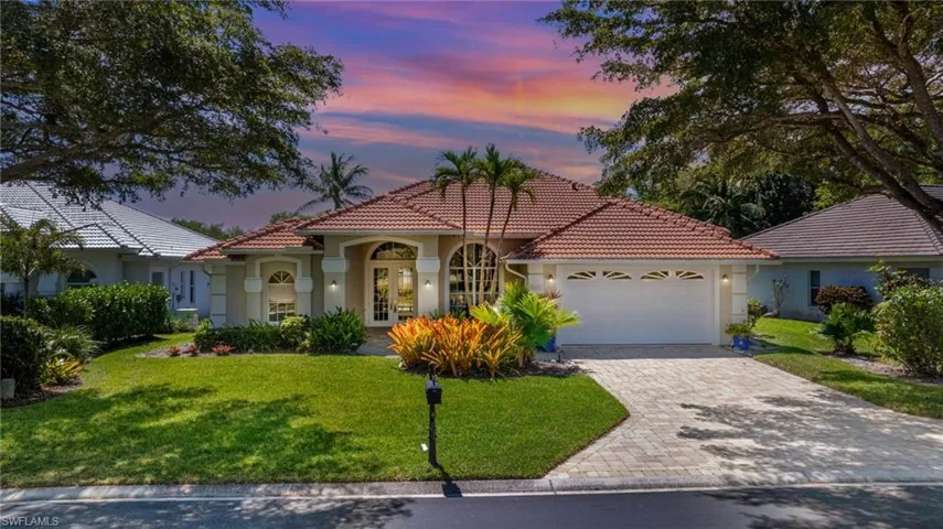 Mediterranean / spanish-style house featuring a tile roof, french doors, a garage, and stucco siding