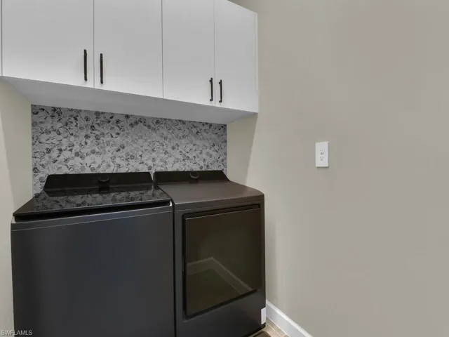 Upgraded washer/dryer, backsplash and added cabinetry