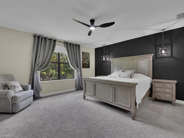Large primary suite with sitting area, large window, and ample living space