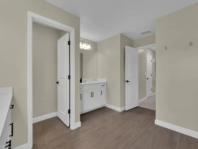 Large bathroom with separate water closet, tile flooring and two sinks/vanities