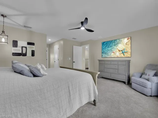 Primary suite features 2 closets, hallway and expansive adjoining bathroom