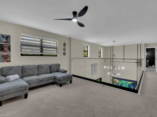 Loft features family room style setting, perfect for entertainment while providing natural light with the glass railing