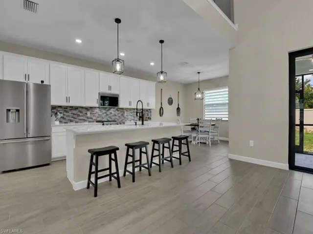 Upgraded kitchen with new appliances, backsplash and hardware