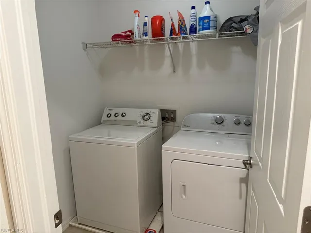 Laundry area featuring washer and dryer and baseboards