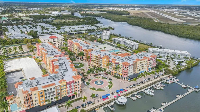 Aerial view of property's location with a large body of water and apartment complex