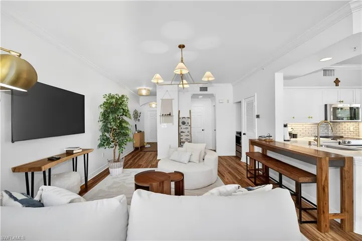 Living room featuring crown molding and wood finished floors