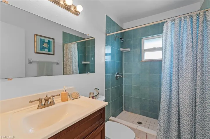 Full bathroom featuring vanity and a stall shower