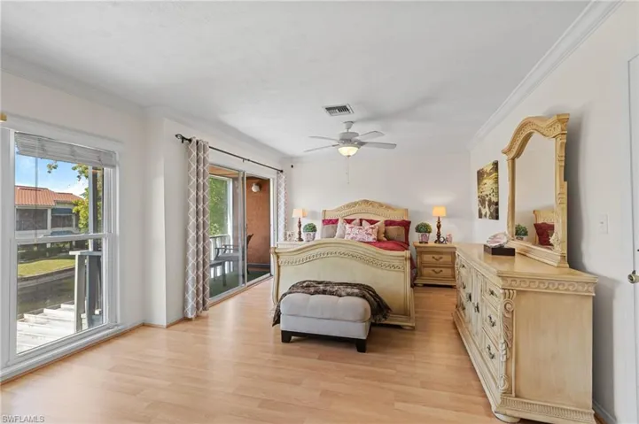 Bedroom featuring crown molding, light wood-type flooring, access to outside, and a ceiling fan