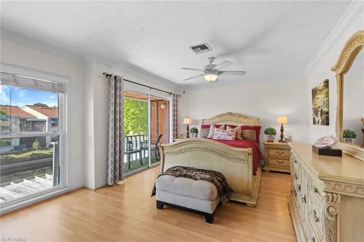 Bedroom featuring light wood finished floors, access to exterior, crown molding, and ceiling fan