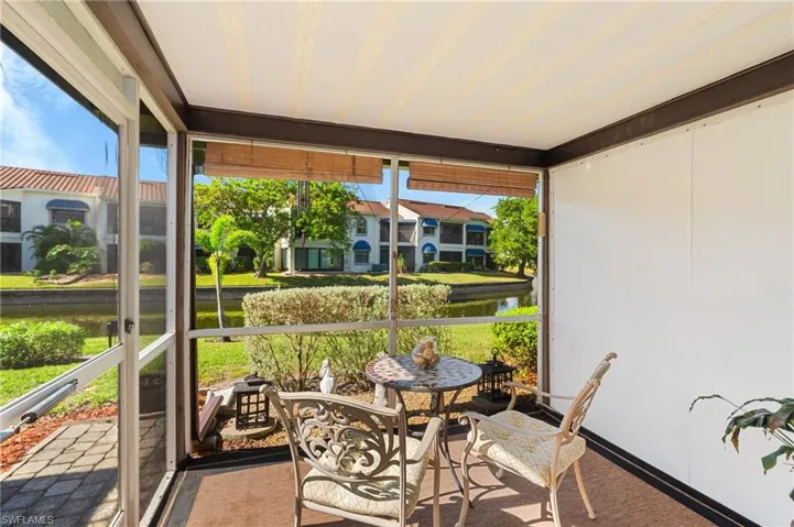 Sunroom featuring a water view