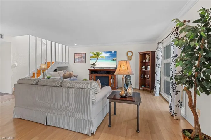 Living room featuring light wood finished floors and stairs