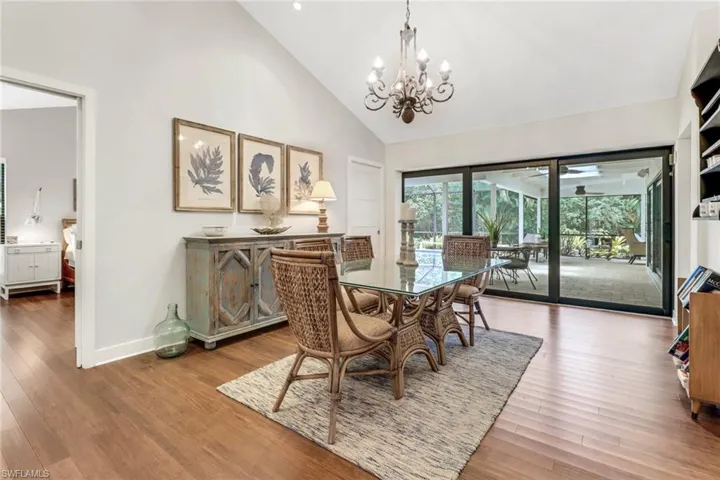 Dining Room just off Primary Bedroom, opens to Covered Lanai Pool Area via Impact Sliding Glass Doors