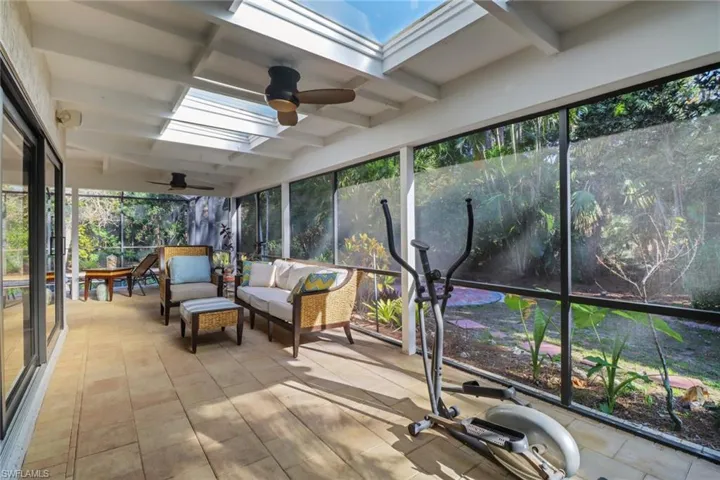 Sunroom featuring a skylight, ceiling fan, and an outdoor living space