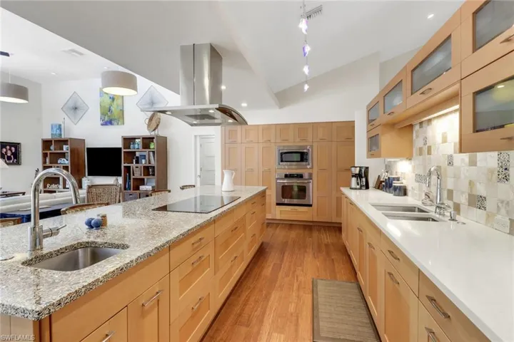Kitchen Pantry Wall with built-ins oven and microwave, island bar sink and induction cooktop