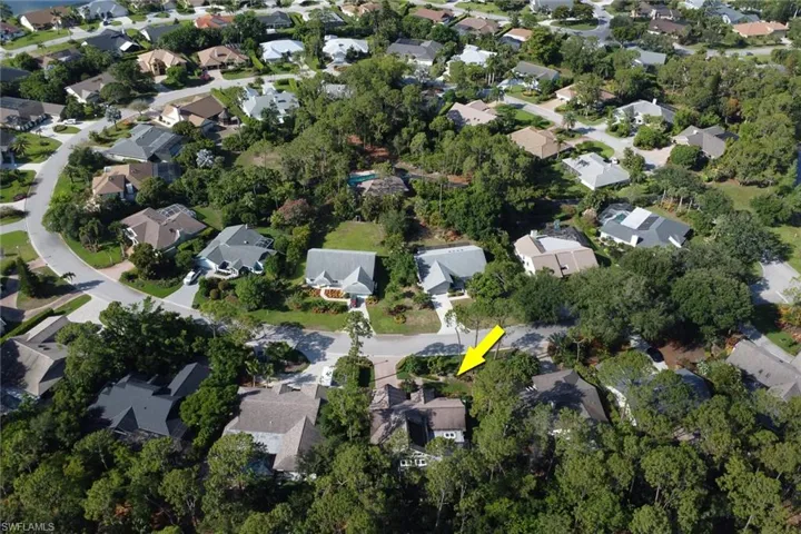 Aerial overview of property's location with nearby suburban area also showing across the street you see a peek at the Woodlands pool