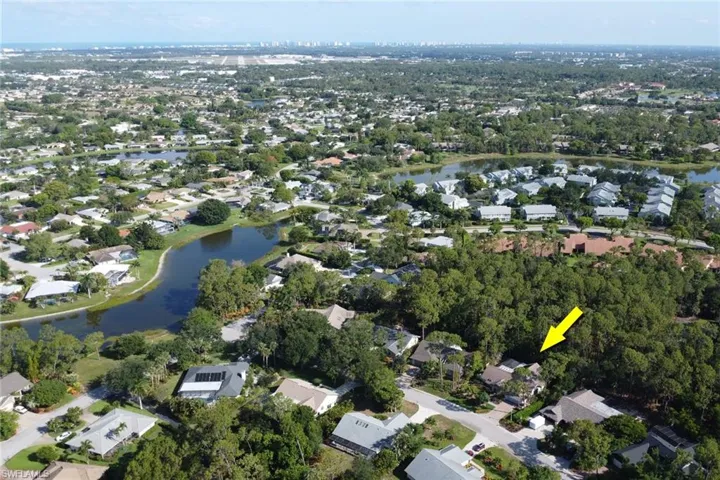 View of property location featuring a large body of water and nearby suburban area