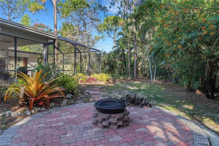 View of patio featuring a fire pit and thelanai