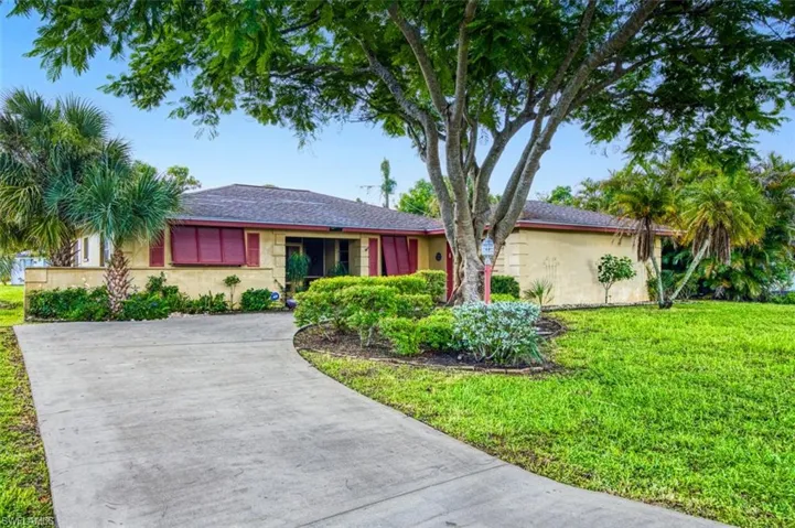 Ranch-style home with a front lawn