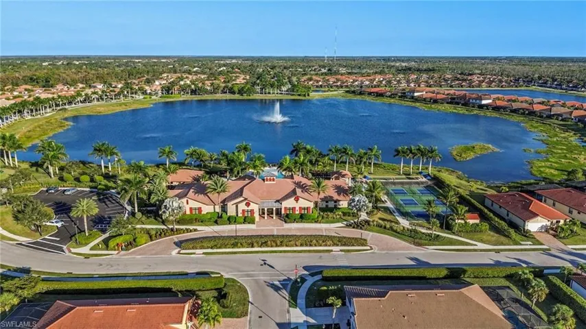 clubhouse with large lake to walk around
