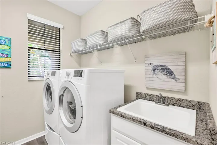 laundry room with tub and dual load washer