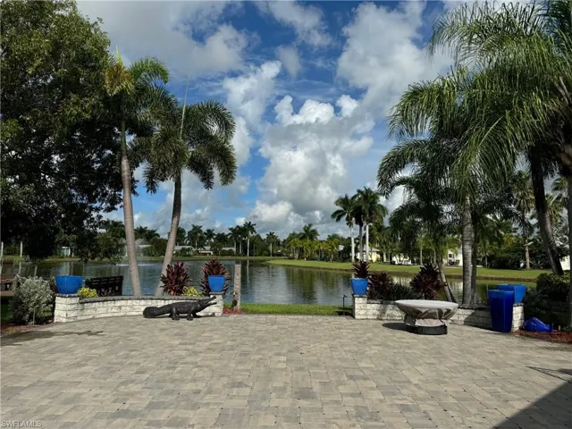 View of community with a fire pit and a water view