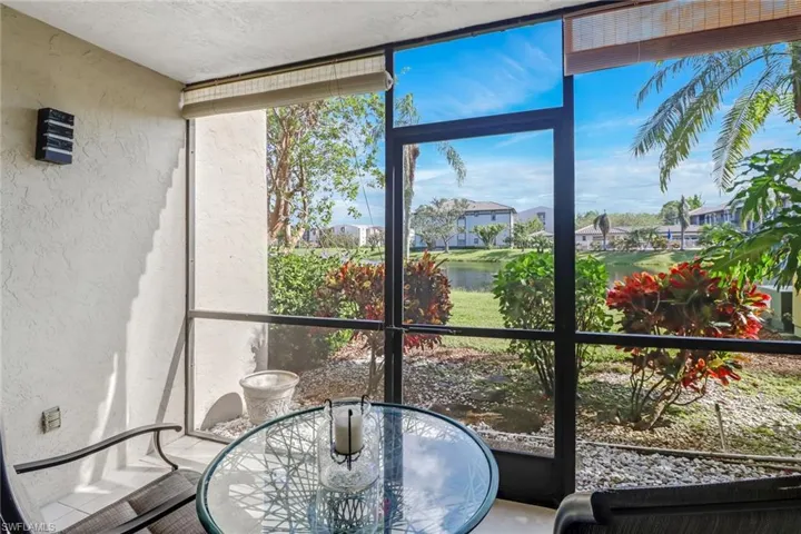 Sunroom featuring a water view