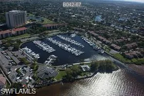 Birds eye view of property with a water view