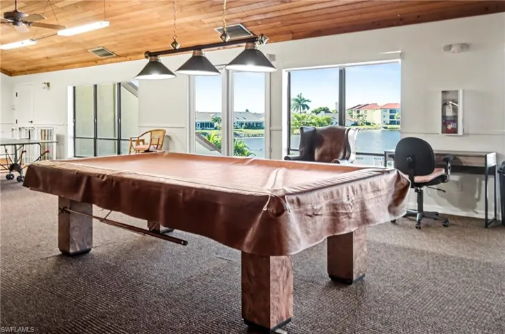 Game room with wood ceiling, billiards, a water view, and lofted ceiling
