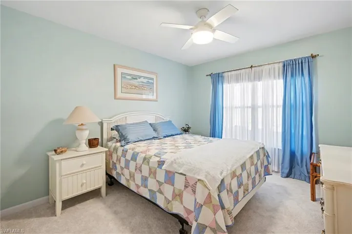 Bedroom featuring ceiling fan and carpet