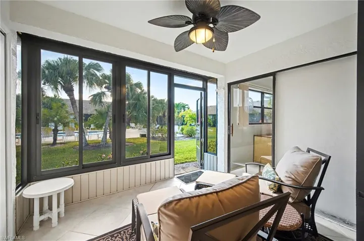 Sunroom / solarium featuring ceiling fan