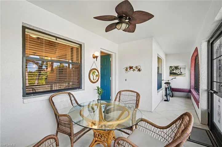 Sunroom / solarium featuring a textured wall and tile flooring
