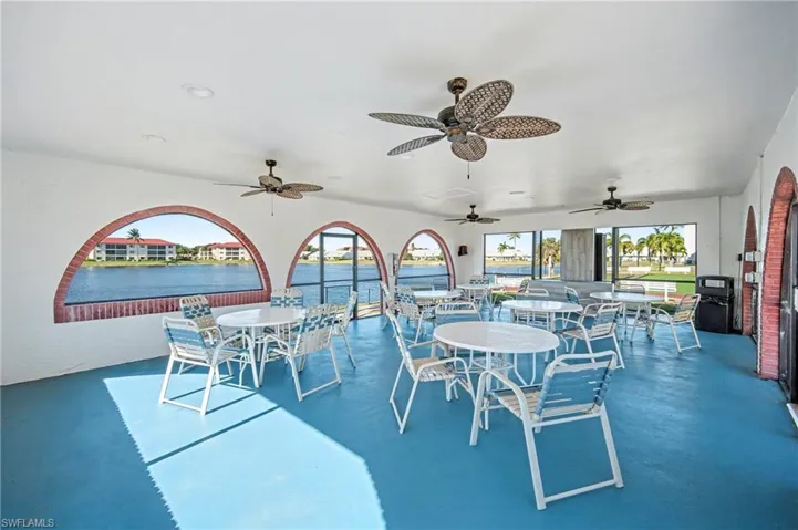 View of patio featuring a water view, outdoor dining area, and a ceiling fan
