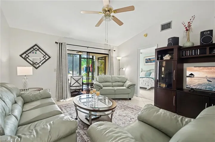 Living room featuring vaulted ceiling and a ceiling fan