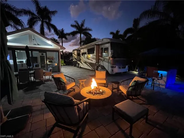 Patio terrace at dusk featuring a fire pit