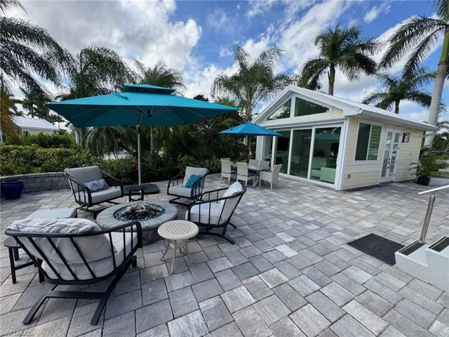 View of patio with an outdoor fire pit