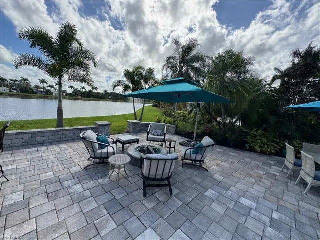 View of patio / terrace with a fire pit and a water view