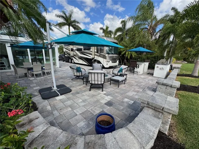 View of patio with a fire pit