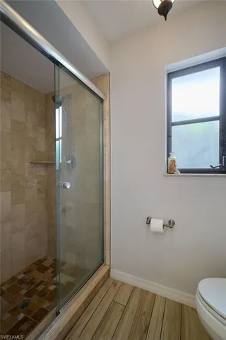 Bathroom featuring a stall shower and wood finished floors