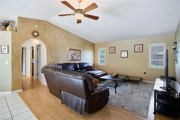 Living area with a ceiling fan and wood finished floors