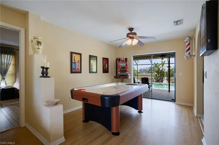 Living area with a ceiling fan and wood finished floors