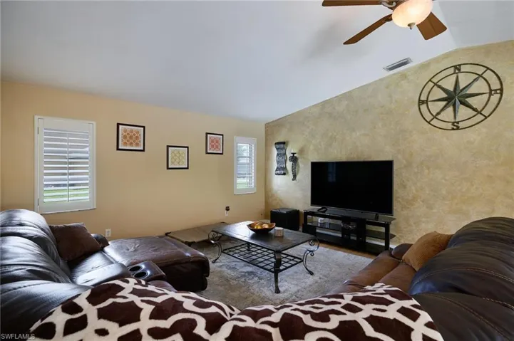 Living area with a ceiling fan and wood finished floors