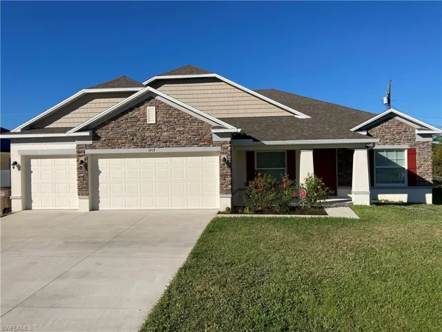View of front facade with 3 car garage.