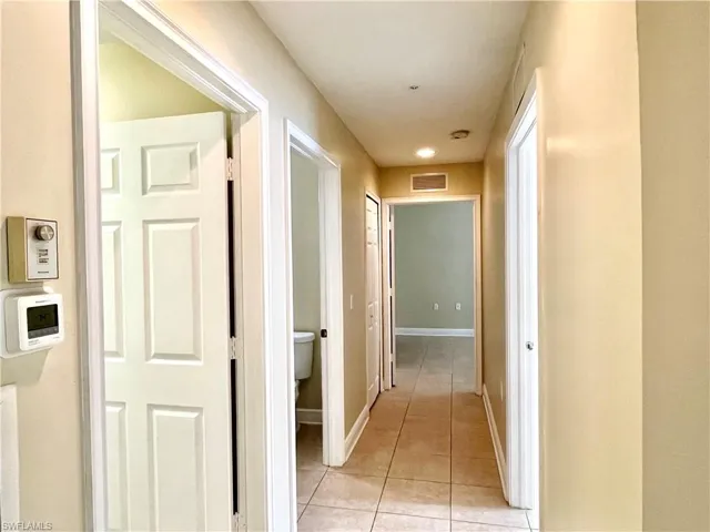 Hallway featuring light tile patterned floors