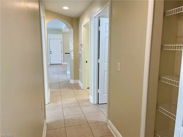 Hall featuring light tile patterned floors