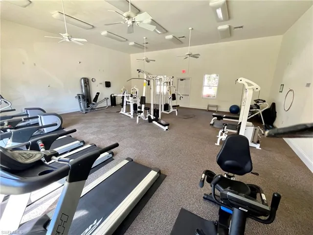 Workout area featuring a towering ceiling