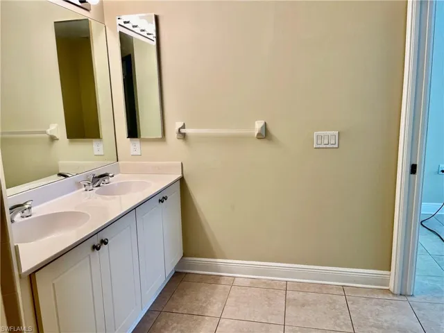Bathroom with vanity and tile patterned flooring