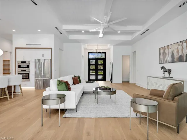 Real Solid Wood Wide Plank Flooring throughout, Tray Ceiling, with wall-to-wall sliders opening to pool & patio